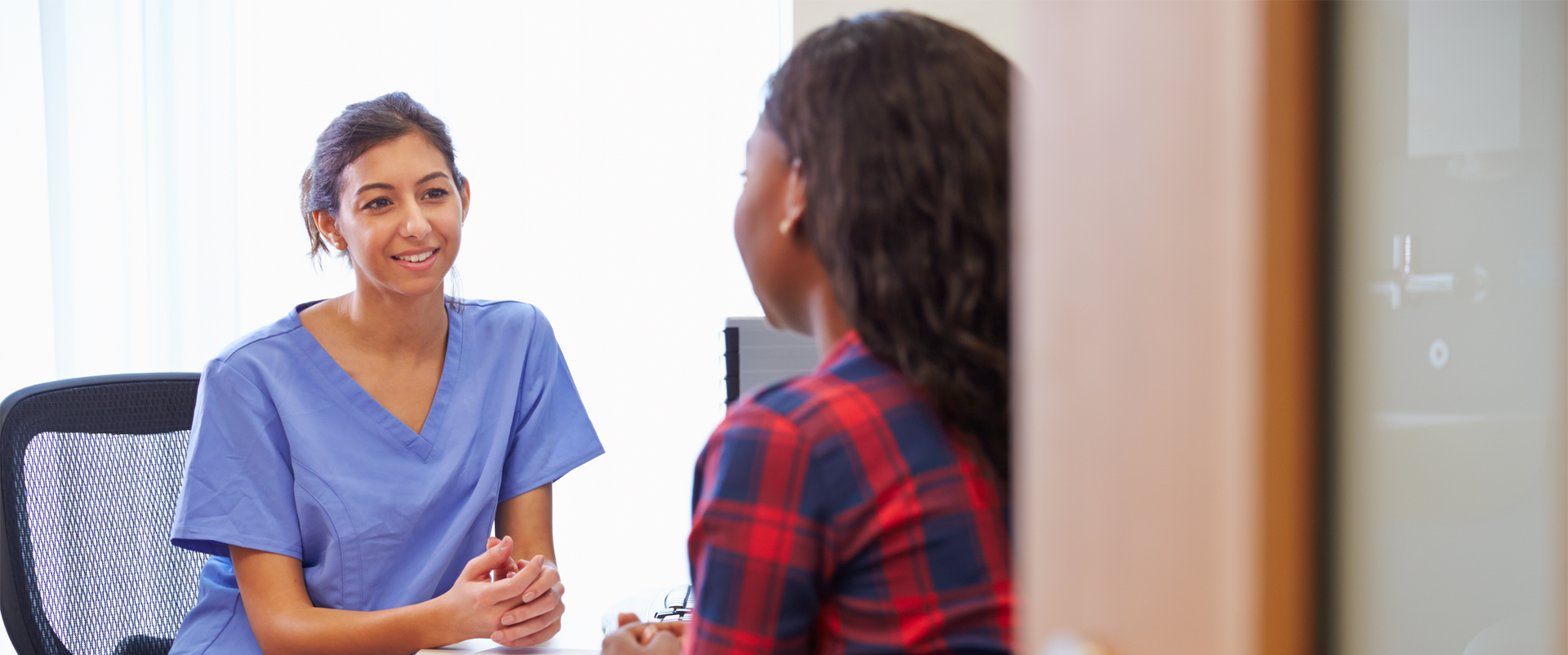 female meeting with provider about pregnancy test